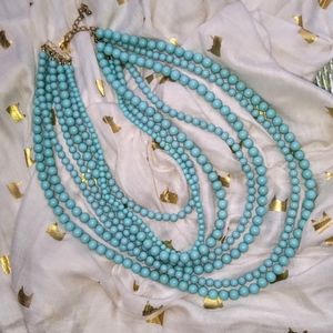 Multi-strand turquoise colored acry bead necklac